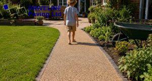clean resin bound garden path ideas linking lawn and patio in a loughton garden