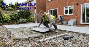 porcelain patio slab being laid on a full mortar bed by a paving installer