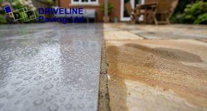 water beading on a porcelain patio slab and soaking into sandstone paving